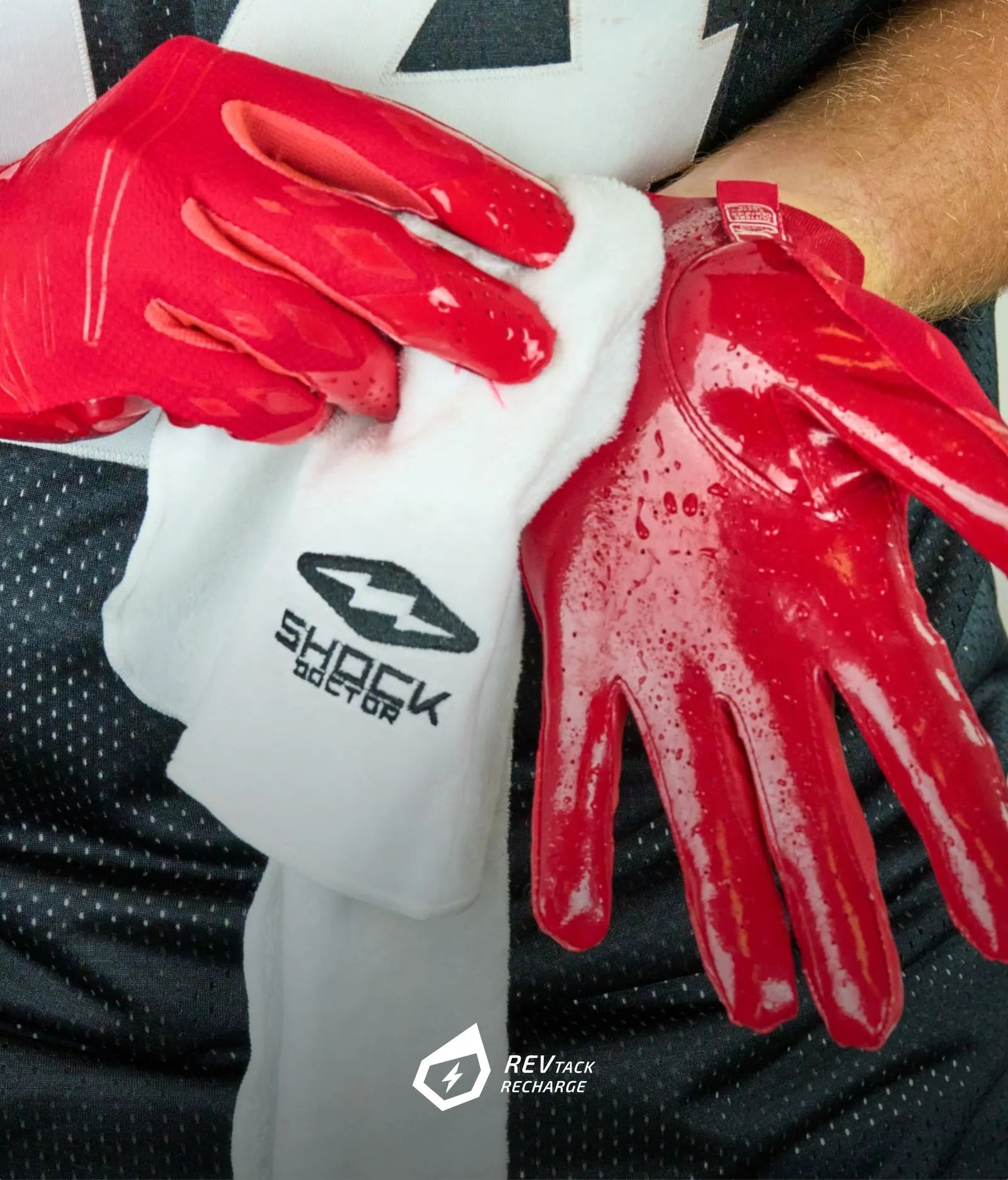 Football athlete showcasing Cutters REV-TACK grip technology. Our REV-TACK technology redefines durability and performance by being self-restoring. Its innovative design ensures that even after heavy use, a simple wipe with a damp cloth is all it takes to restore its superior stickiness.