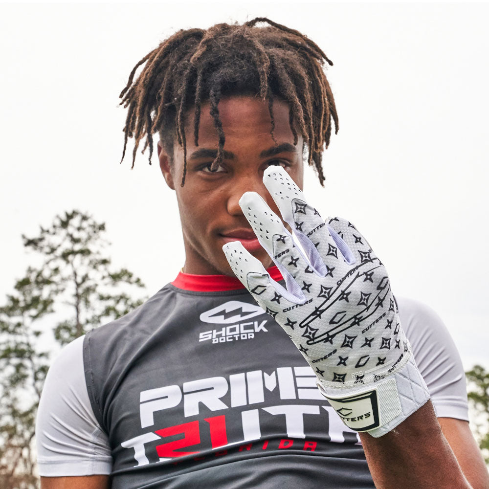 Youth 7v7 Football Player Wearing Cutters White/Black Lux Rev Pro 5.0 Limited-Edition Receiver Gloves