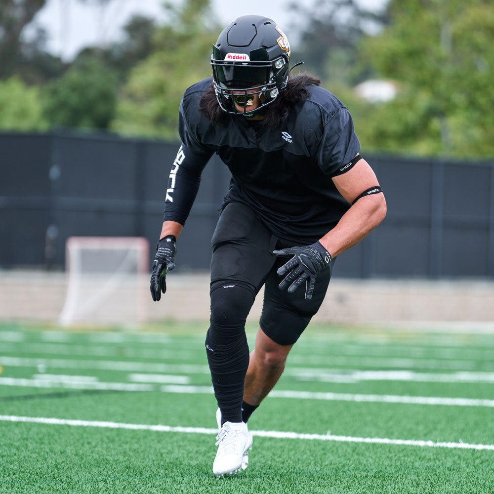 Lifestyle Detail Shot of Football Player Wearing Cutters Gamer 5.0 Padded Receiver Gloves in Black