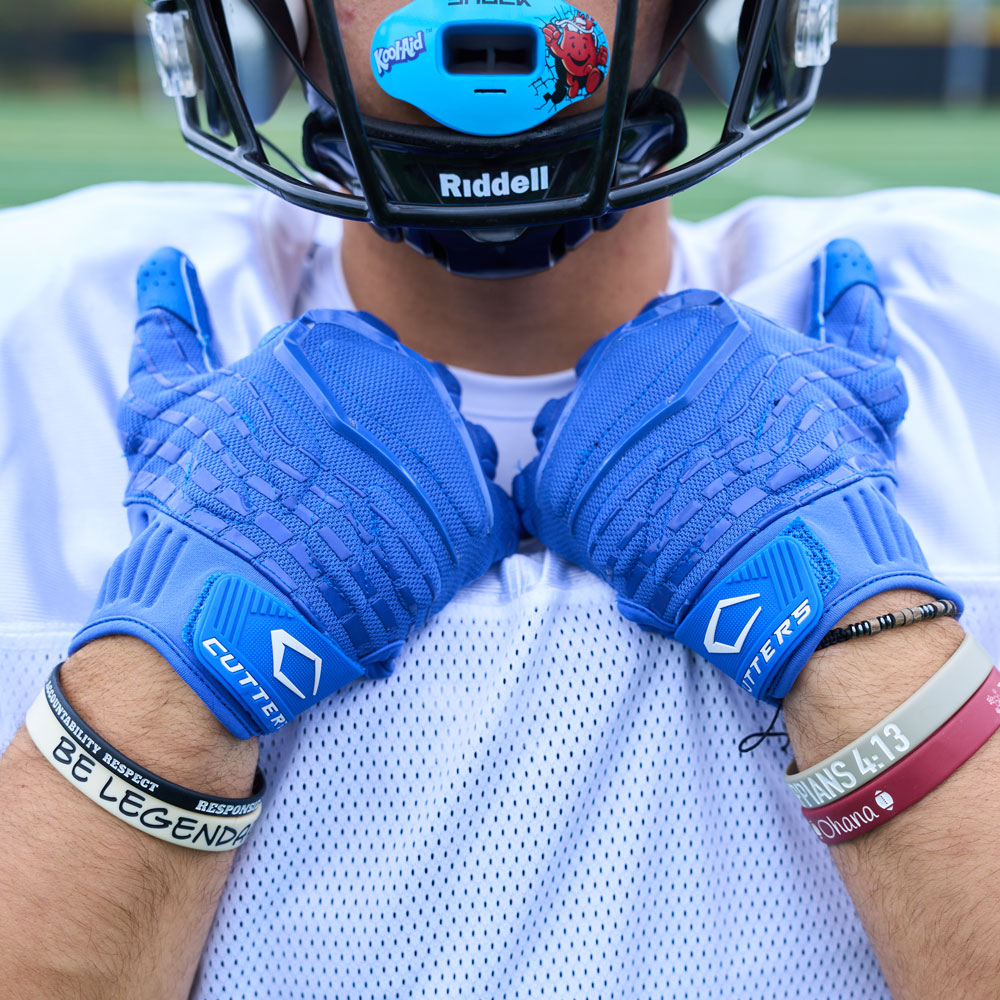 Lifestyle Detail Shot of Football Player Wearing Gamer 5.0 Padded Receiver Gloves in Royal Blue