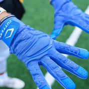 Lifestyle Detail Shot of Football Player Wearing Cutters Gamer 5.0 Padded Receiver Gloves in Royal Blue