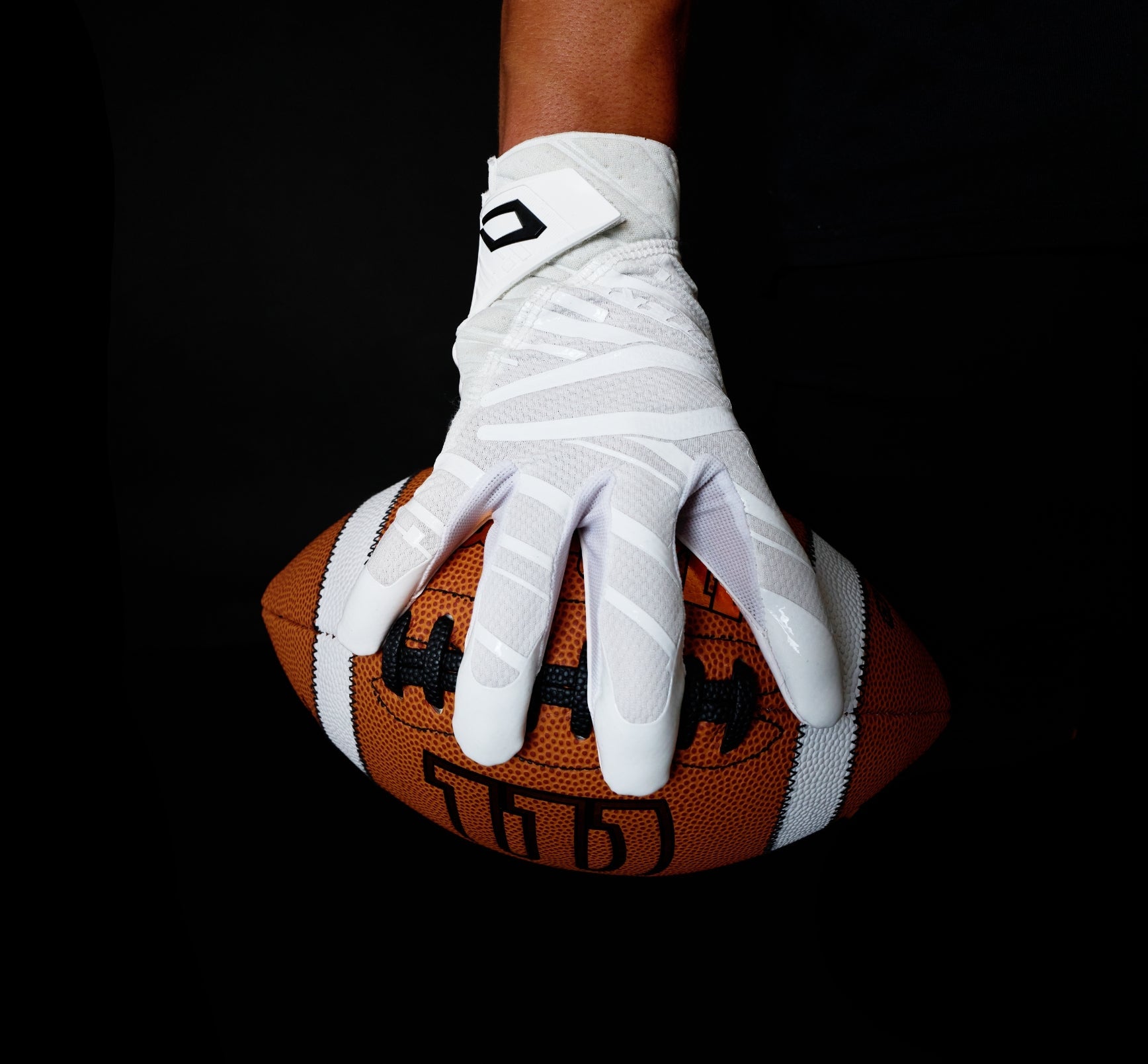 Image of Football Athlete Gripping Ball with Cutters C-TACK Technology