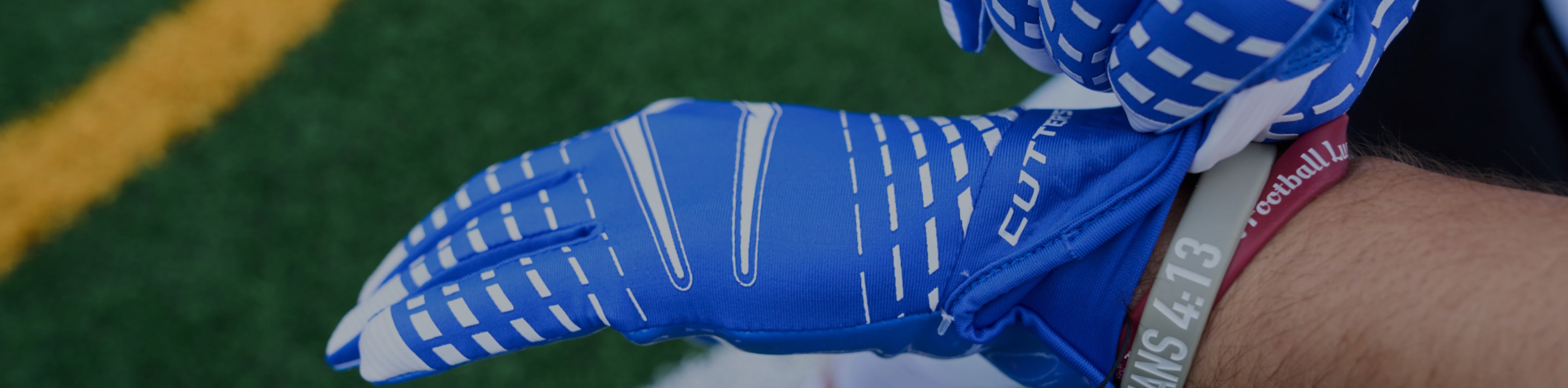 Header image for the 'Rev 5.0' Collection by Cutters Sports. A youth football player wears blue gloves, showcasing elite grip and performance designed for pros.