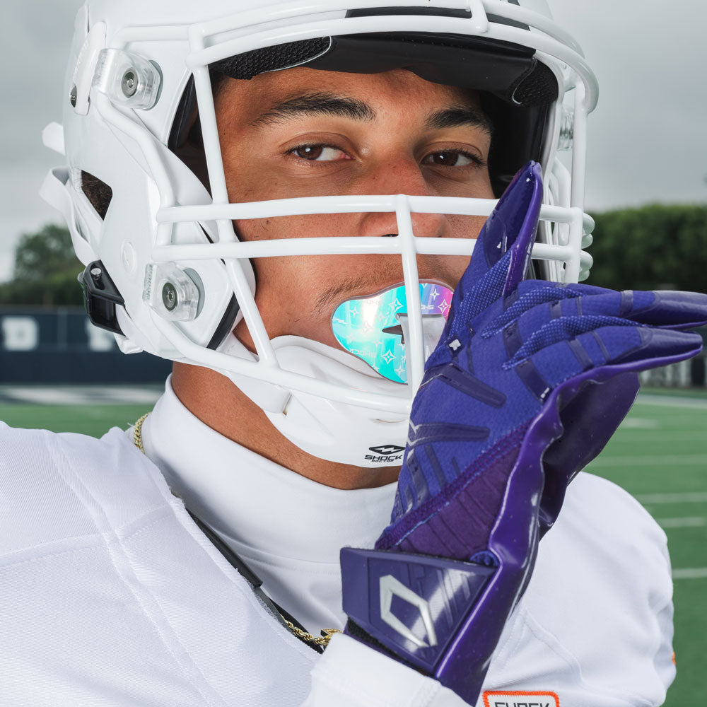 Youth Tackle Football Athlete Wearing Cutters Rev Pro 6.0 Solid Football Gloves in Purple