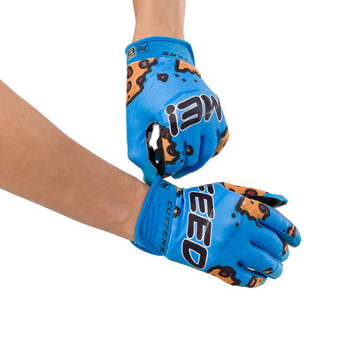 Cutters Sports Feed Me Rev 5.0 Limited-Edition Youth Football Receiver Gloves - Blue - Football Player Pulling Glove Over Wrist for Better Fit