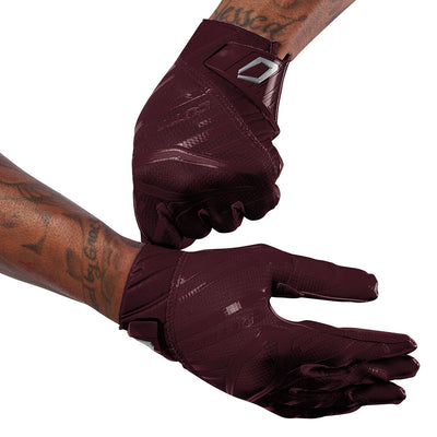 Cutters Sports Rev Pro 6.0 Solid Receiver Football Gloves - Maroon Red - Football Player Pulling Glove Over Wrist for Better Fit