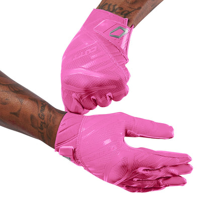 Cutters Sports Rev Pro 6.0 Solid Receiver Football Gloves - Pink - Football Player Pulling Glove Over Wrist for Better Fit