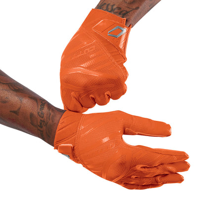 Cutters Sports Rev Pro 6.0 Solid Receiver Football Gloves - Orange - Football Player Pulling Glove Over Wrist for Better Fit