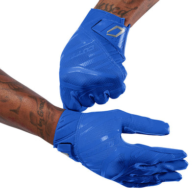 Cutters Sports Rev Pro 6.0 Solid Receiver Football Gloves - Royal Blue - Football Player Pulling Glove Over Wrist for Better Fit