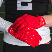 Athlete Wearing Cutters Gamer 6.0  Red Padded Receiver Gloves
