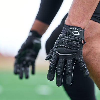 Lifestyle Detail Shot of Football Player Wearing Cutters Gamer 5.0 Padded Receiver Gloves in Black