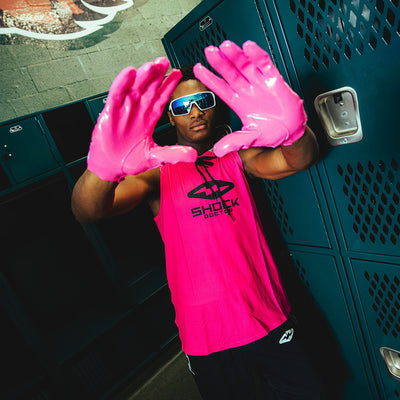 Youth 7v7 Football Athlete Wearing Cutters Sports Rev Pro 6.0 Solid Receiver Football Gloves in Pink