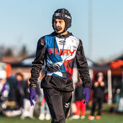Youth Football Player Wearing Cutters Sports Purple Rev Pro 5.0 Receiver Gloves